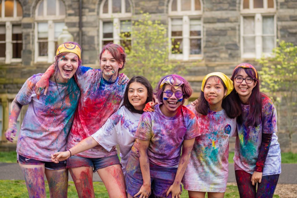 A group of six students during the annual Holi celebration on Healy Lawn.