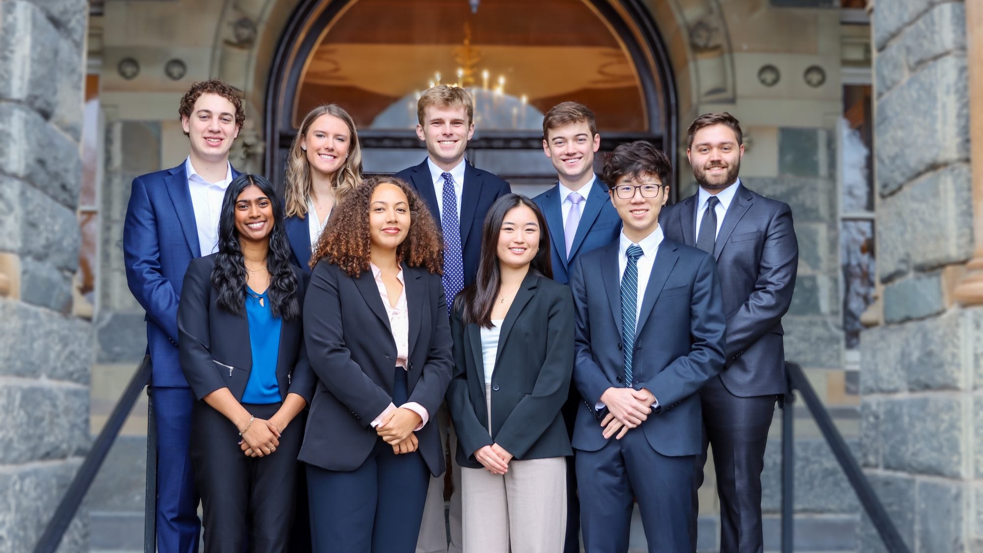 The credit union&#039;s 9-person Board of Directors poses for a photo on the steps of Healy Hall
