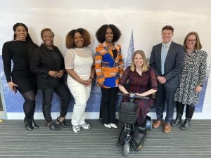 A group of colleagues in the Office of Office of Student Equity & Inclusion leadership team stand together and pose for a picture at Georgetown.