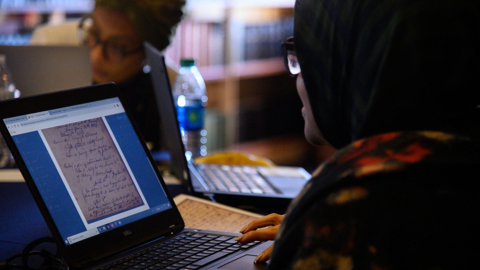 A student studies a document on a laptop