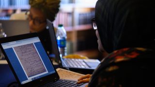 A student studies a document on a laptop