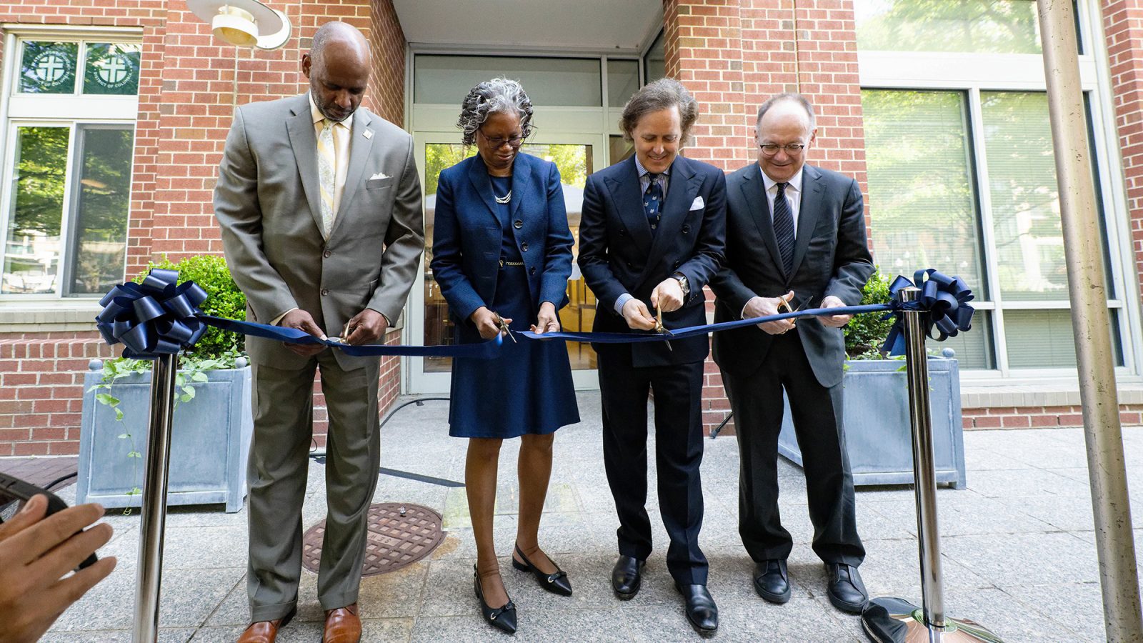 Cutting the ceremonial ribbon to officially open the Ralph Lauren Center are (l to r) Wayne Turnage, D.C.&#039;s Deputy Mayor for Health and Human Services; Lucile Adams-Campbell, PhD, founding director of the Ralph Lauren Center; David Lauren, son of Ralph Lauren and president of the Ralph Lauren Corporate Foundation; and Georgetown University President John J. DeGioia.