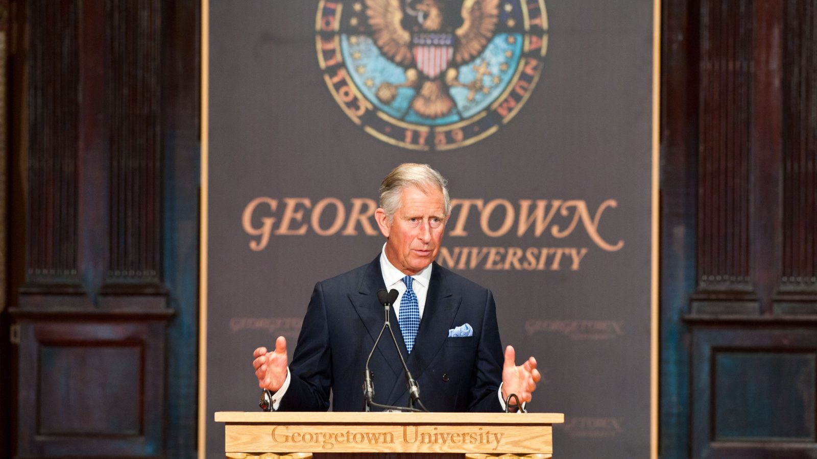 King Charles stands at a podium to deliver remarks at an event in Gaston Hall.
