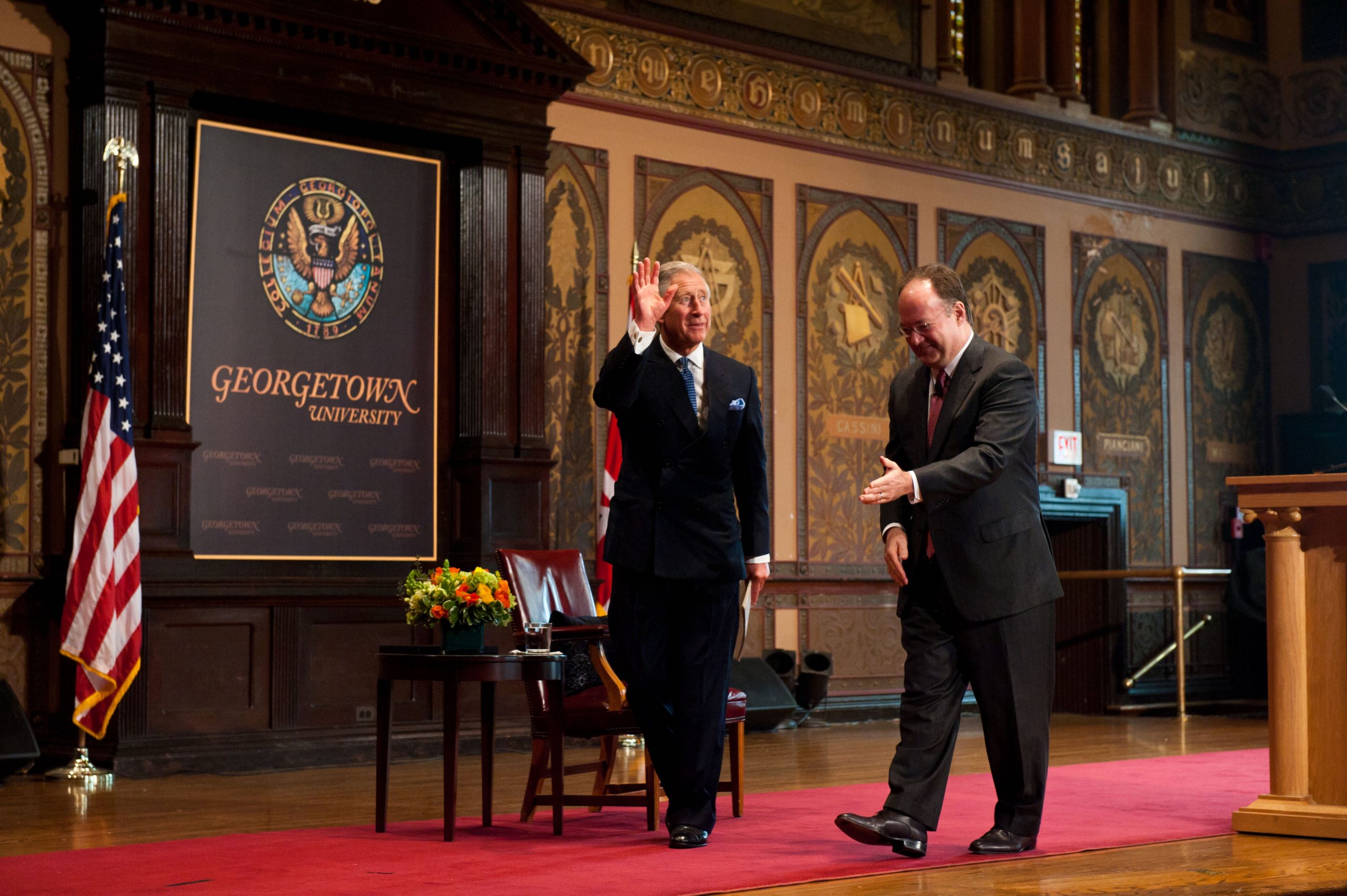 King Charles and Georgetown President John J. DeGioia walk off the stage at Gaston Hall.