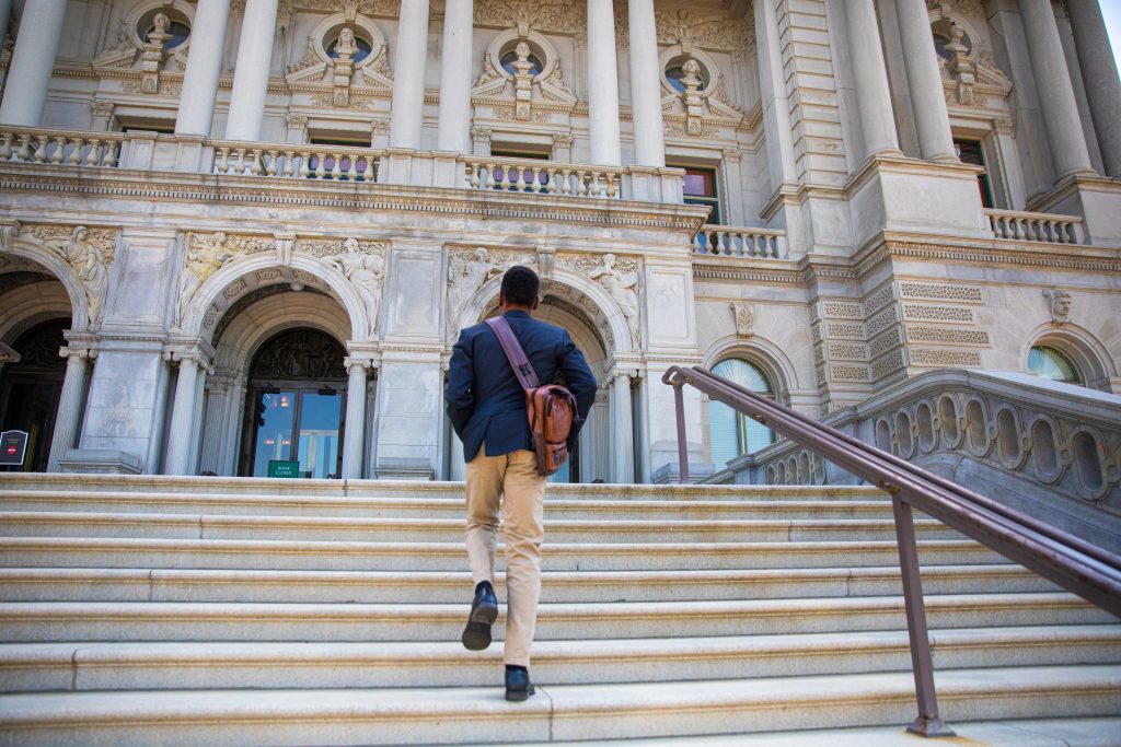 Gandawa walks up the steps outside of the Library of Congress.