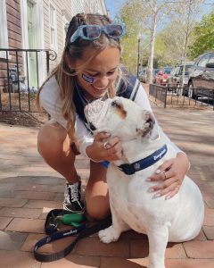 Anna Shaver (C'23) poses with Jack outside of the front gates
