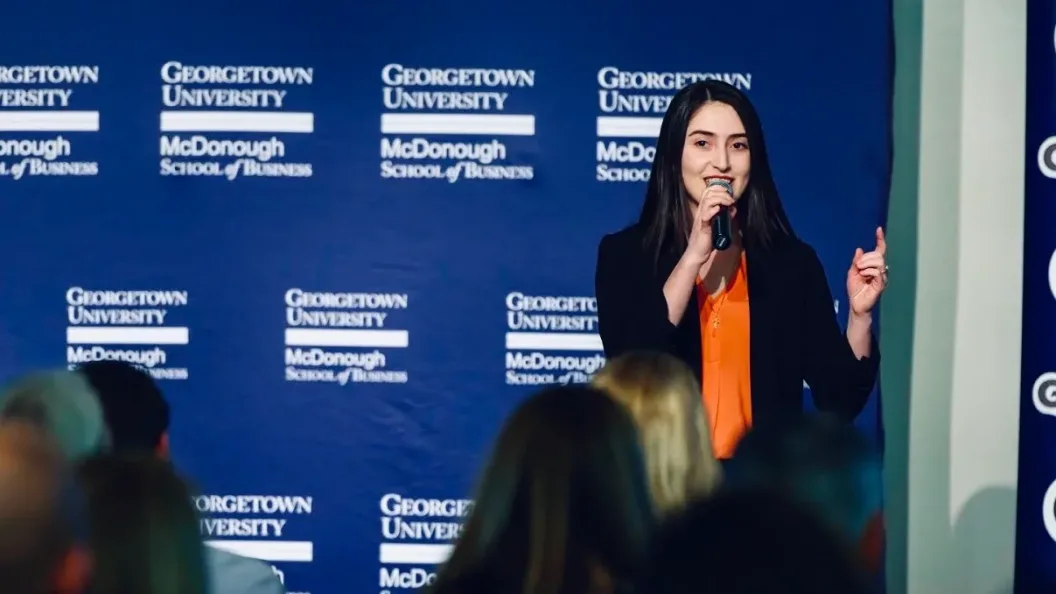 Alumna Salome Mikadze (B&#039;22) speaks against a background that reads &quot;McDonough School of Business.&quot;