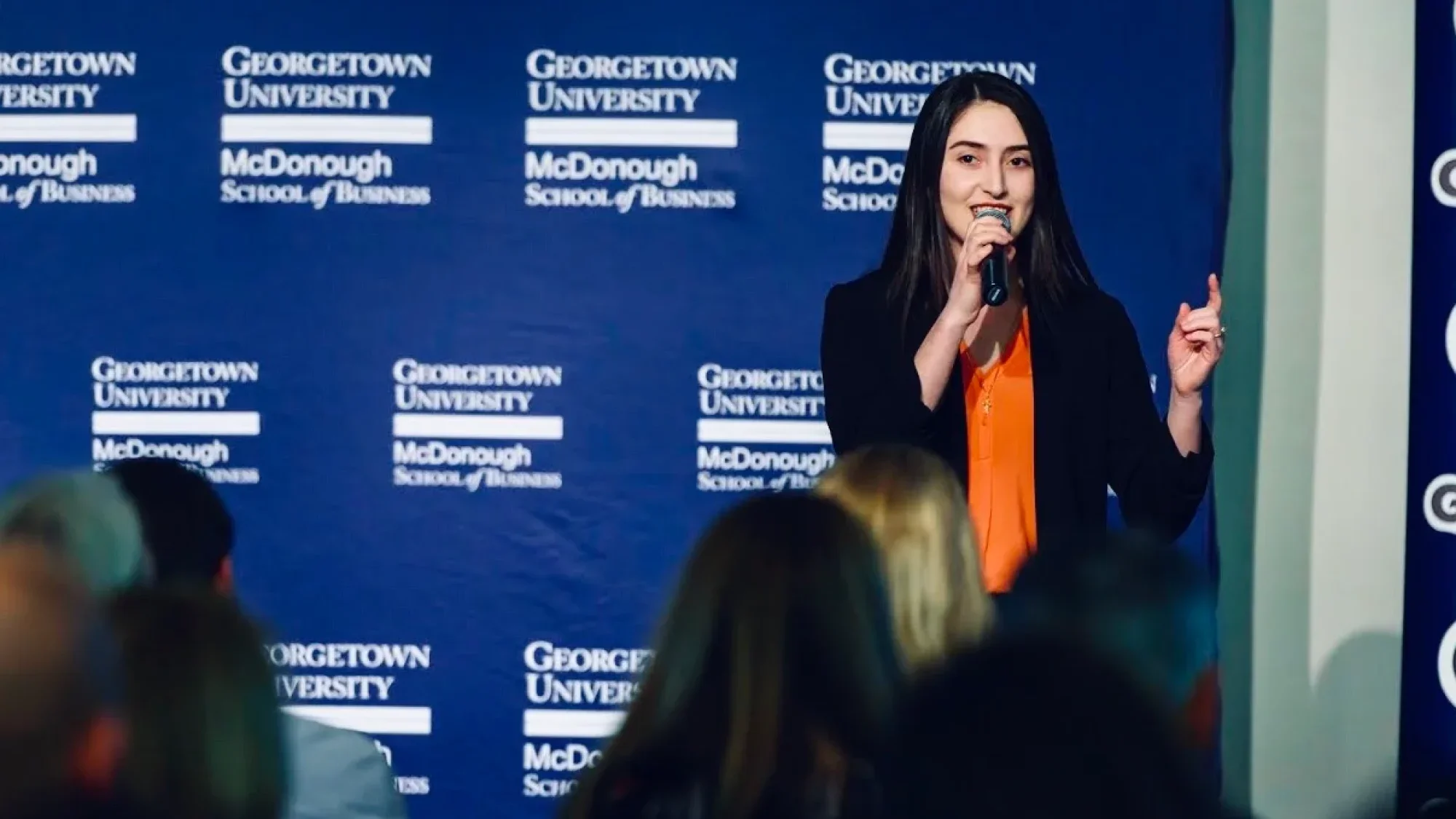 Alumna Salome Mikadze (B&#039;22) speaks against a background that reads &quot;McDonough School of Business.&quot;