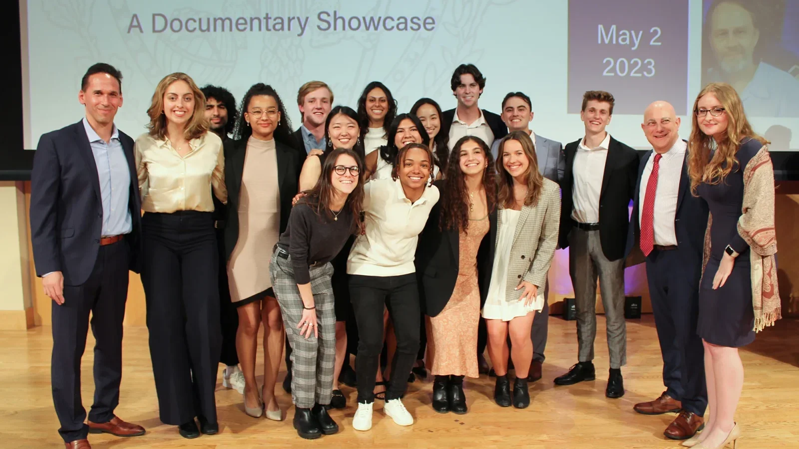 Students in the Making An Exoneree program pose on stage.