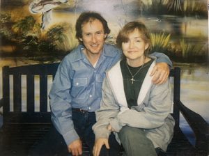 John Kinsel Sitting next to a woman on a bench