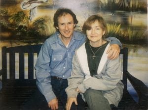 John Kinsel Sitting next to a woman on a bench