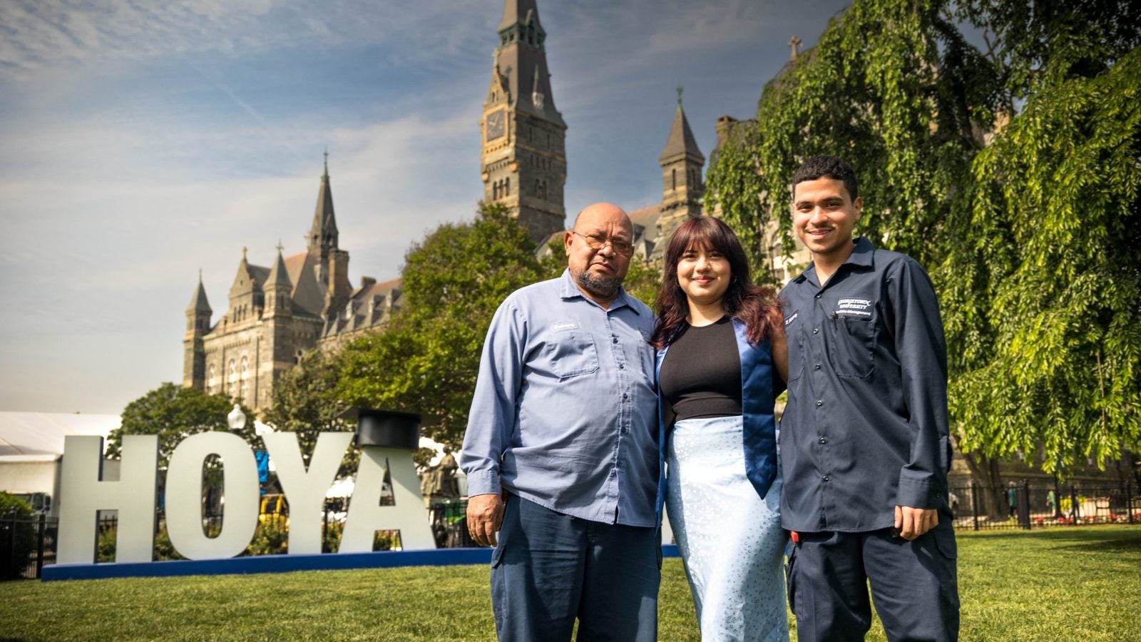 The Velasquez family stands in front of the Hoya Saxa sign on Georgetown's front lawn.