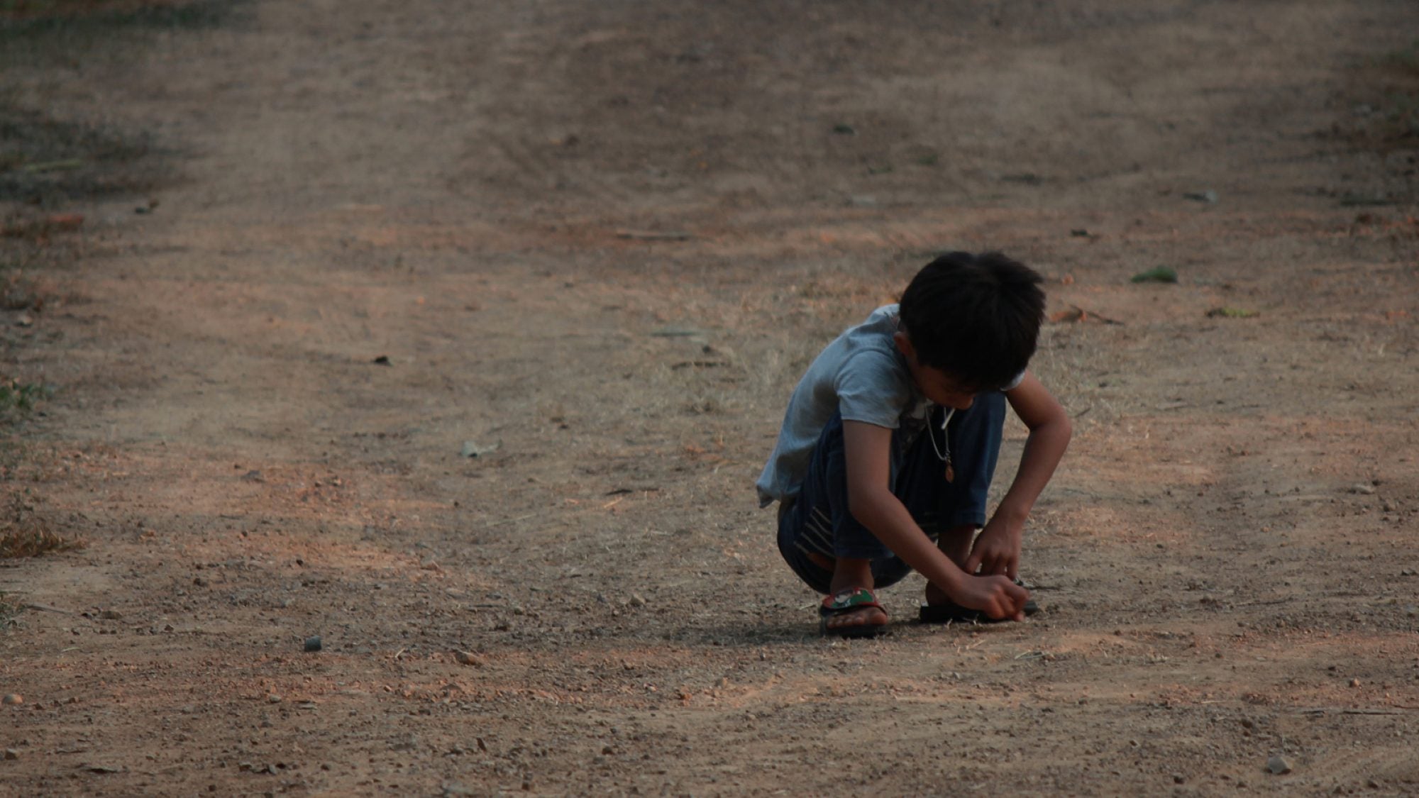 Young boy plays alone