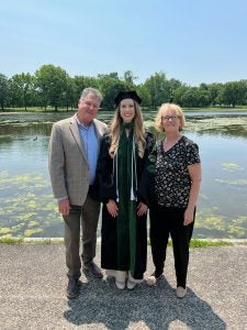 Fitzgerald standing with her parents outside.