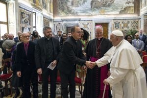 Fr. Mark Bosco, S.J., shakes hands with Pope Francis