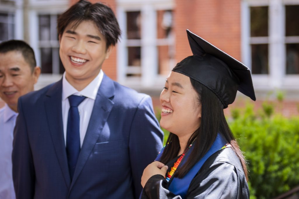 Sofia Chen Ma (B'23) wears a graduation cap and laughs with her brother, an incoming first year.