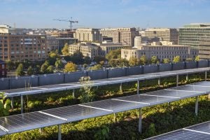 The rooftop of 55 H with solar panels on a clear day.