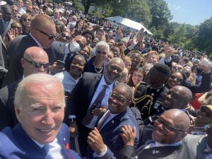 Jackson Mittleman (C'23), far right, poses for a selfie with President Biden after the signing of the Bipartisan Safer Communities Act in summer 2022.