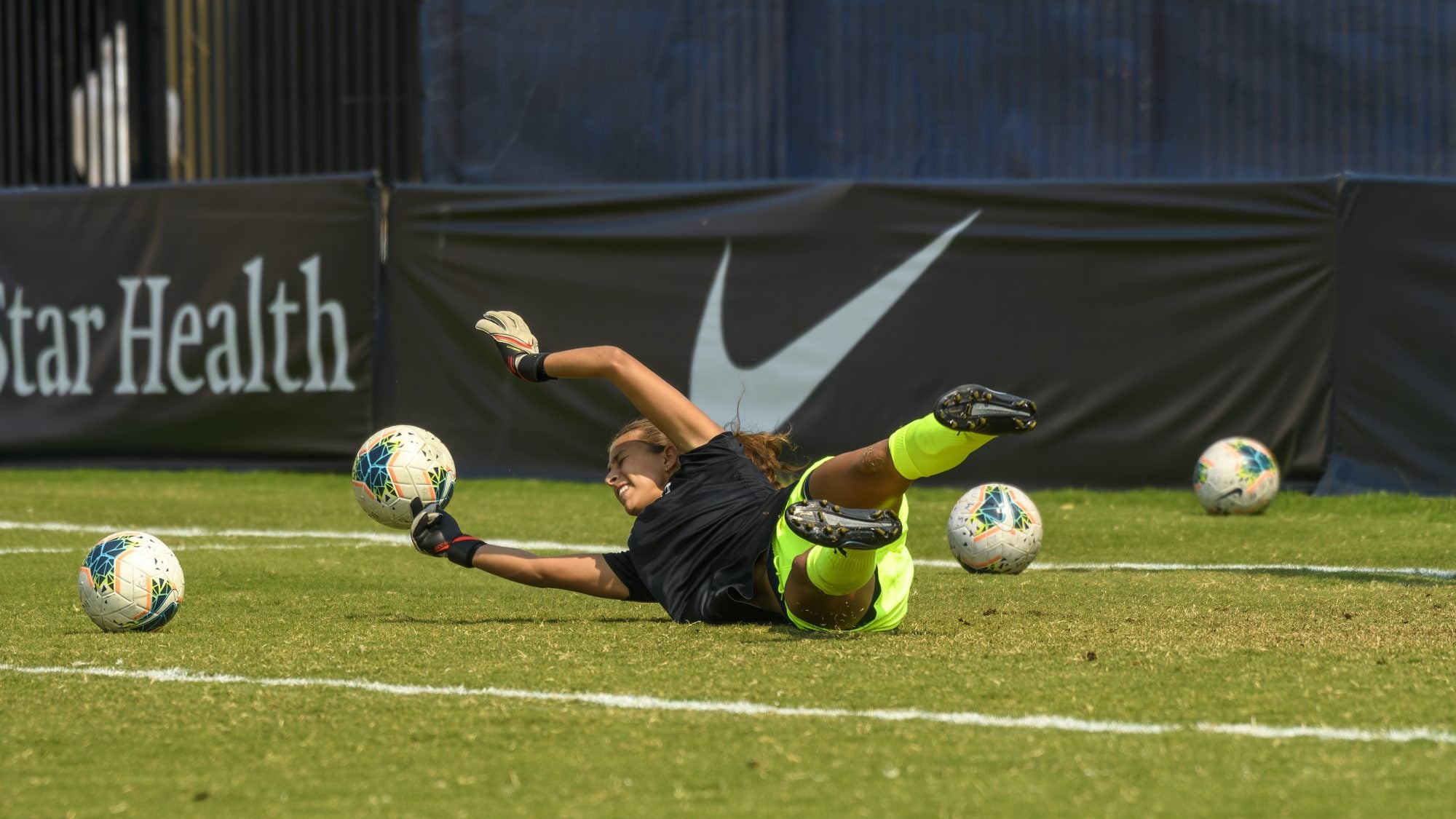 Lara Larco (C&#039;15) falls to the field and reaches out her arms to catch a soccer ball at a women&#039;s soccer game vs. Rutgers.