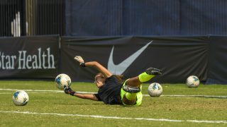 Lara Larco (C&#039;15) falls to the field and reaches out her arms to catch a soccer ball at a women&#039;s soccer game vs. Rutgers.