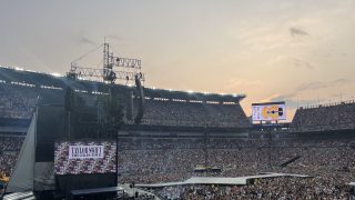 Photo of Eras Tour concert in a packed stadium