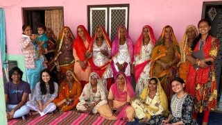 A group of women in traditional Indian clothing.