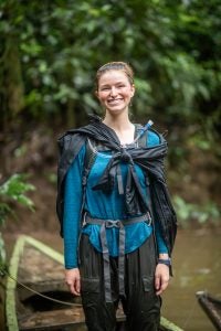 Headshot of Mae in outdoor clothing in the rainforest