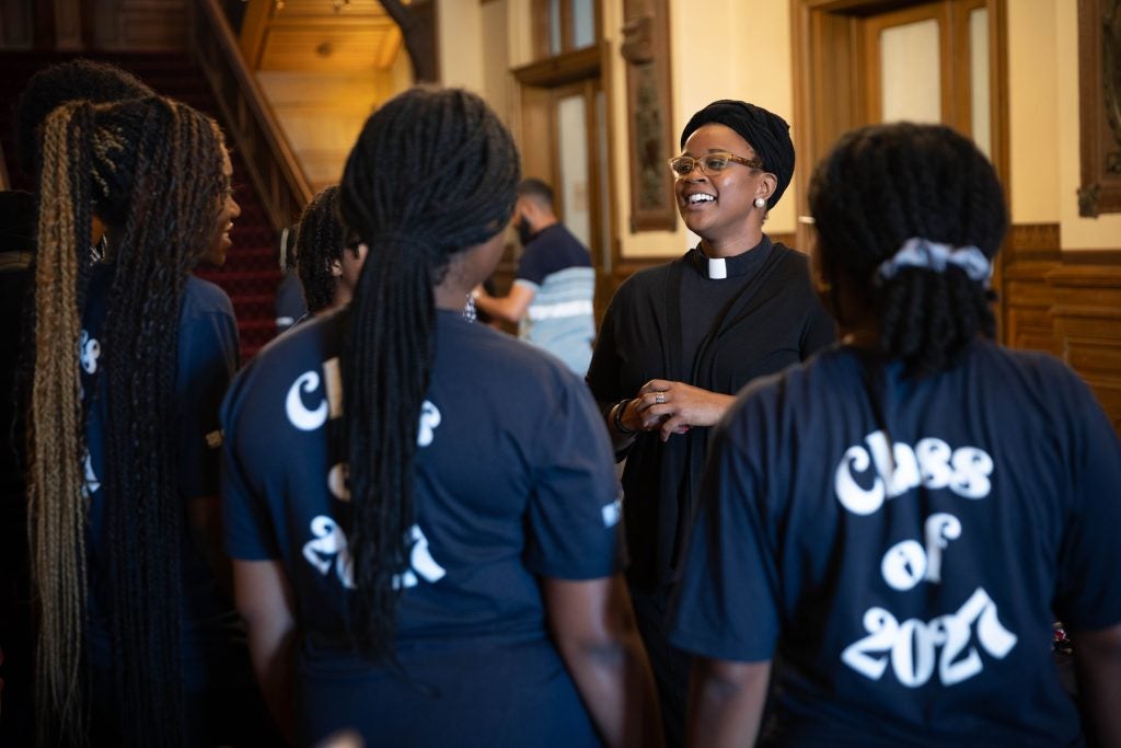 A group of students talks to a chaplain in Healy