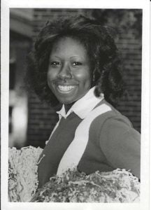 Black and white headshot of a woman in a cheerleader uniform