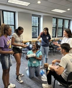 A group of six people learning CPR