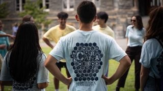 Students in a circle with one student wearing a blue shirt from CURA program