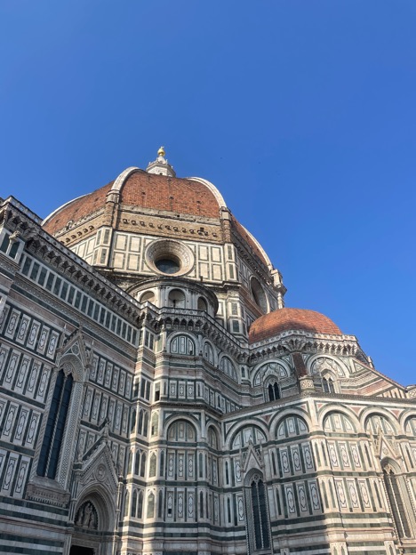 Cathedral of Santa Maria del Fiore sits against a blue, cloudless sky