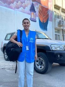 Doumit in her UN uniform in front of a car