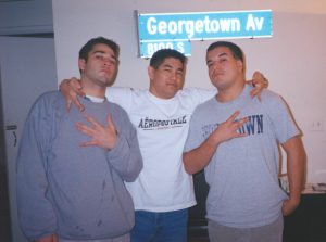 Three young man in a group photo in a house