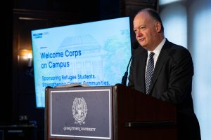 John J. DeGioia speaks at a podium.