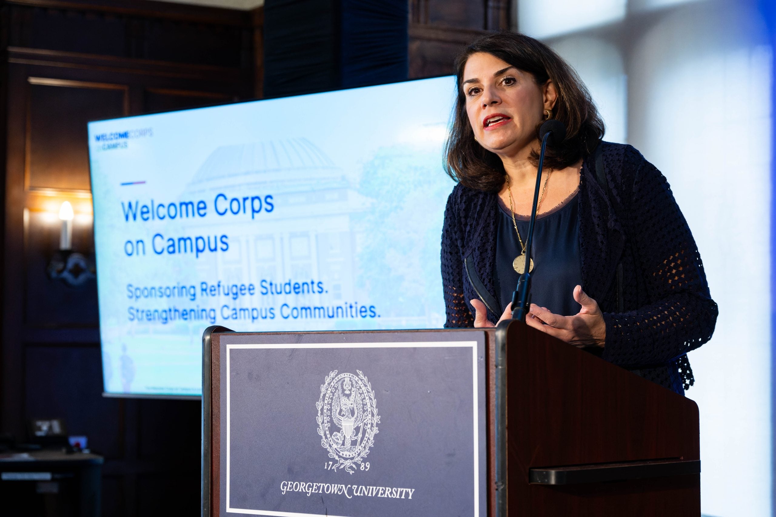 Julieta Valls Noyes speaks at a podium.