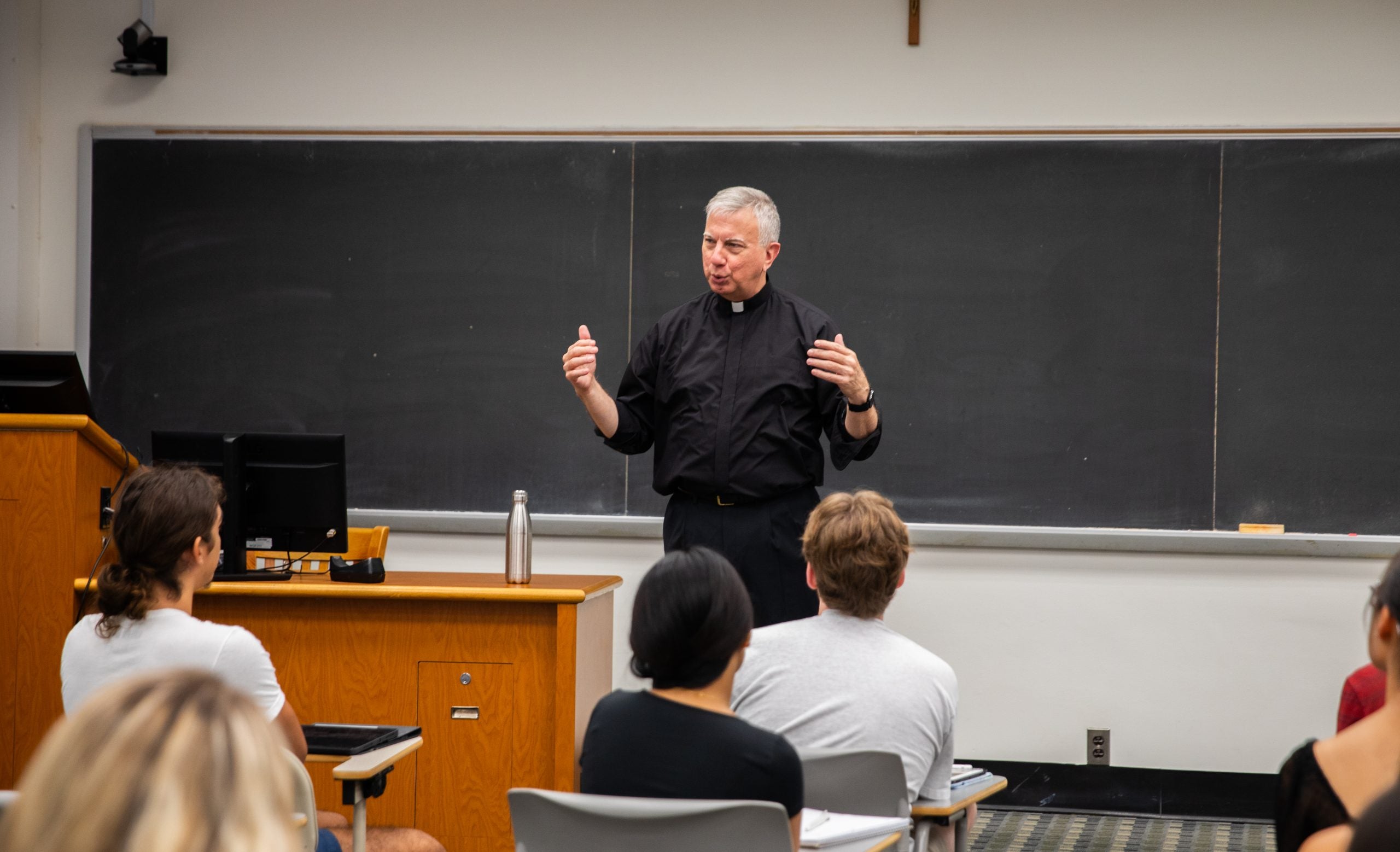 Steck teaching in front of a classroom