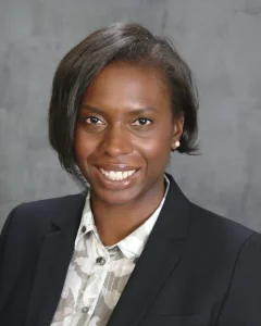 Lauren Cherry is a fellow in Georgetown Law’s Center on National Security. She smiles at the camera in a black suit and white patterned blouse.