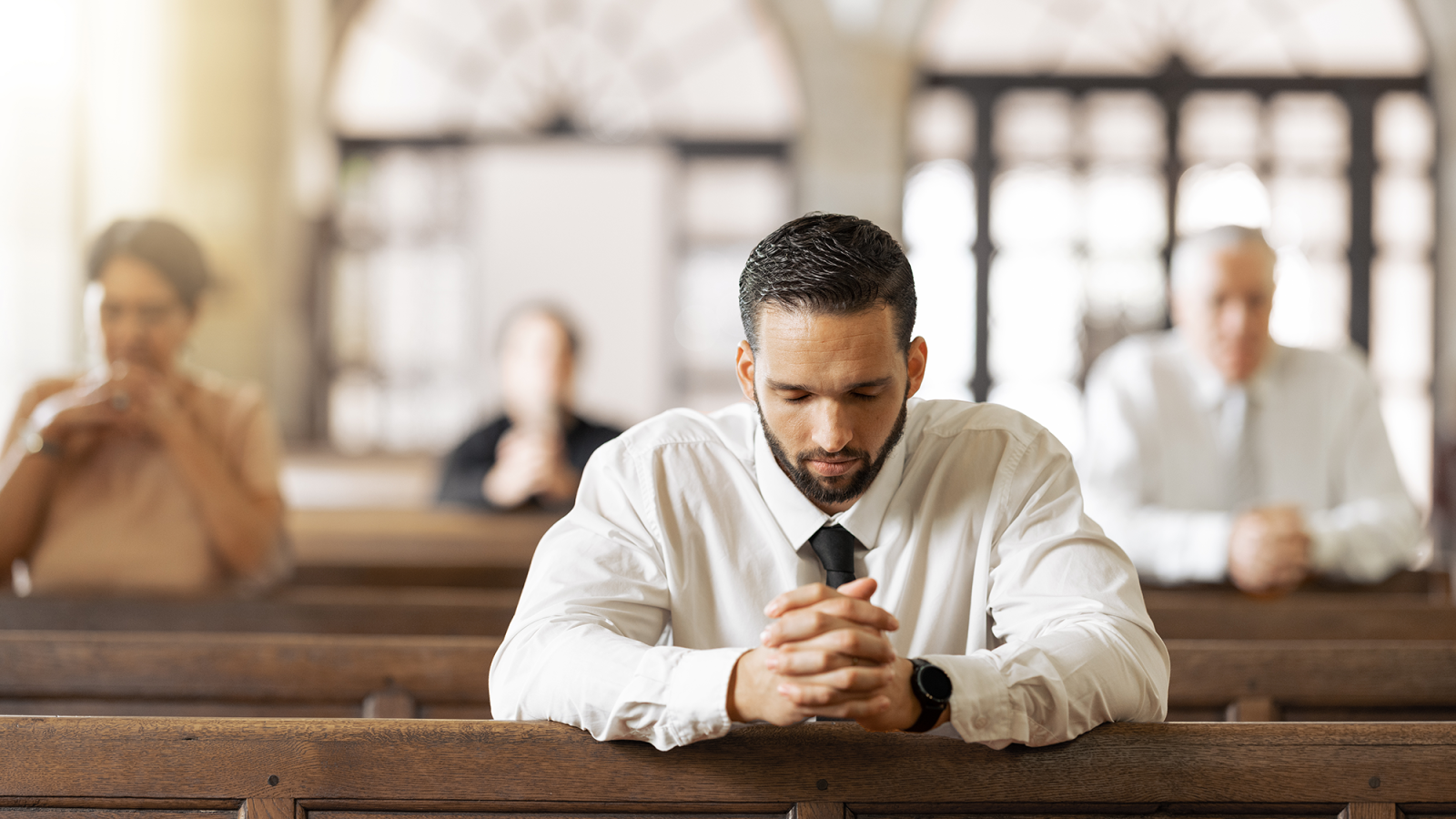 Young man prayers in a Christian church