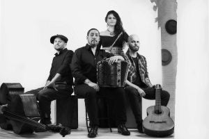 Brittes ensemble, posing together with instruments.