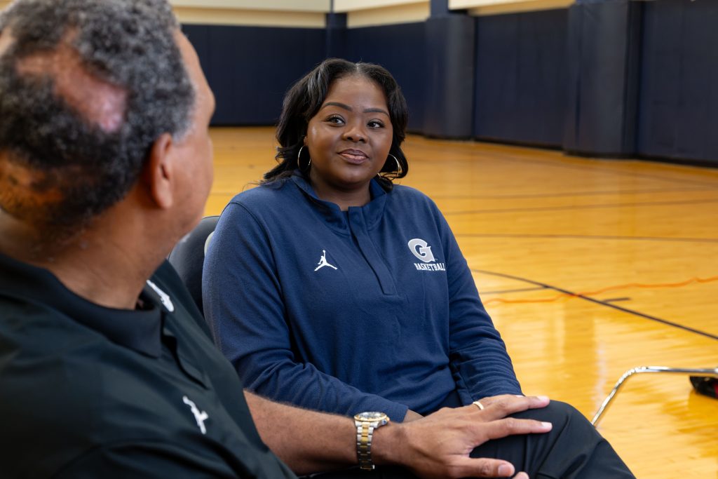 Tasha Butts, the late head coach of Georgetown's women's basketball team, sits on the court for a magazine interview.