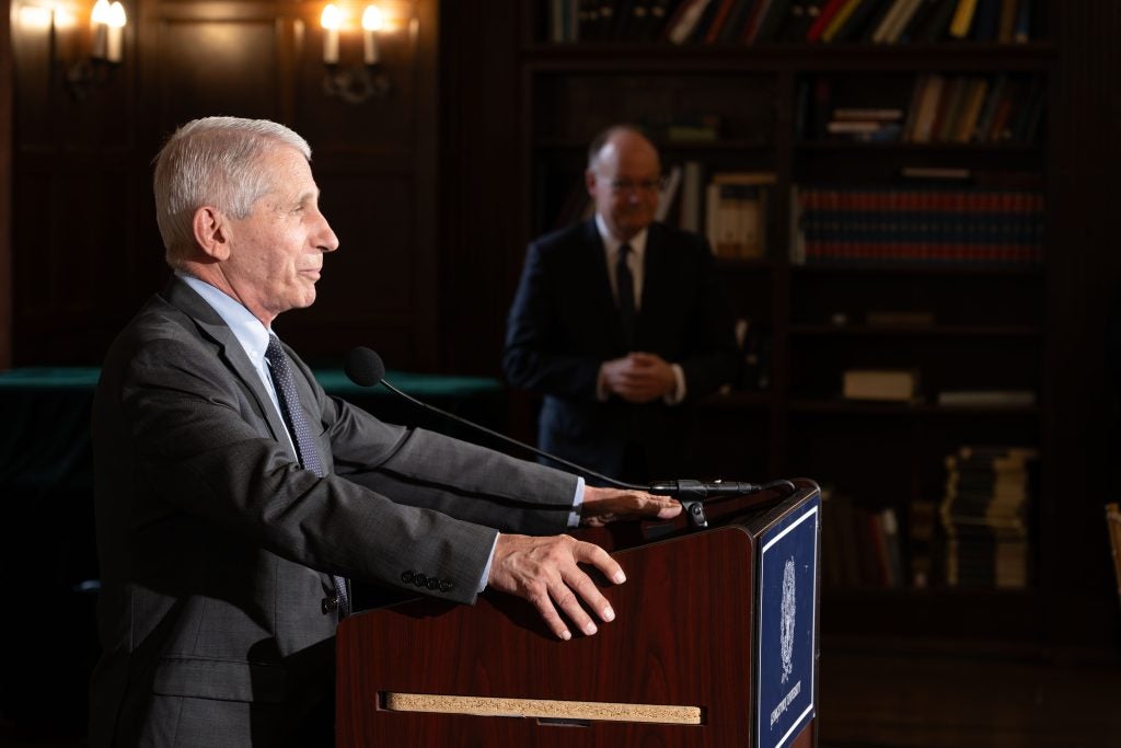 Dr. Anthony Fauci speaks behind a podium during an event at Georgetown University.