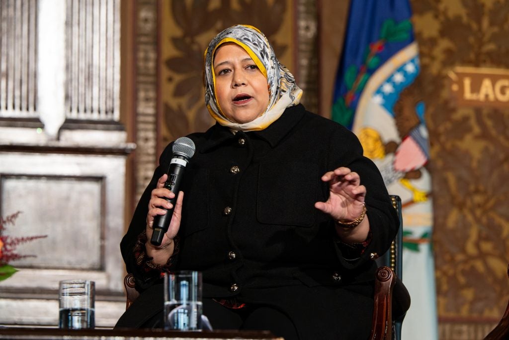 Muna Luqman speaks on the stage of Gaston Hall at an awards ceremony.