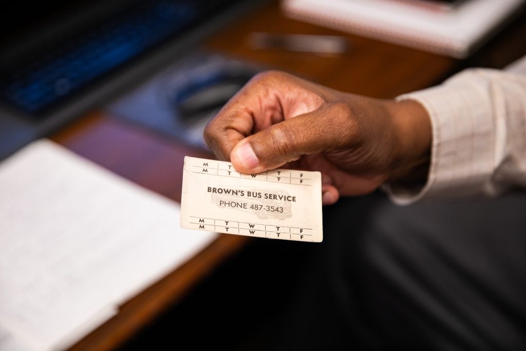 Al Brown holds up a ticket stub that says "Brown's Bus Lines," which was a ticket for his father's bus lines in the 1960s.