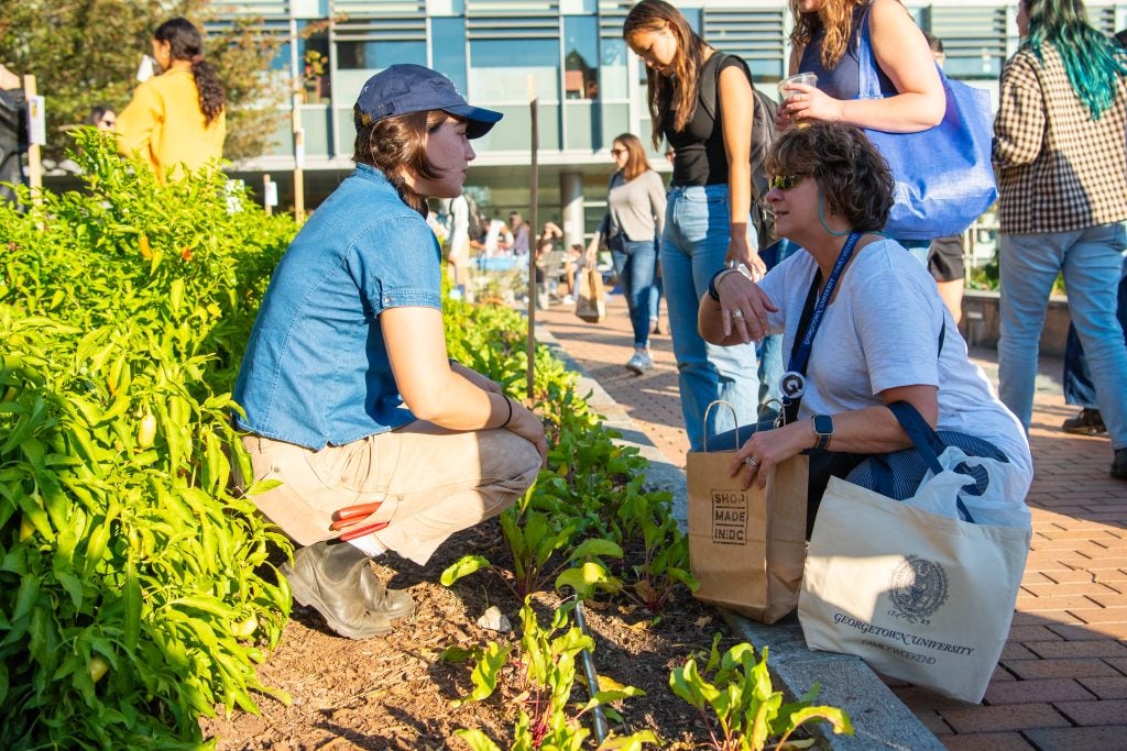 Two women talking at the Hoya Harvest Garden