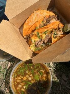 Two birria tacos with Consommé