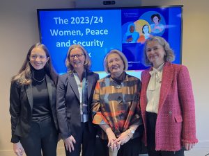 Four women stand in front of a blue screen that says "The 2023/24 Women, Peace and Security Index."