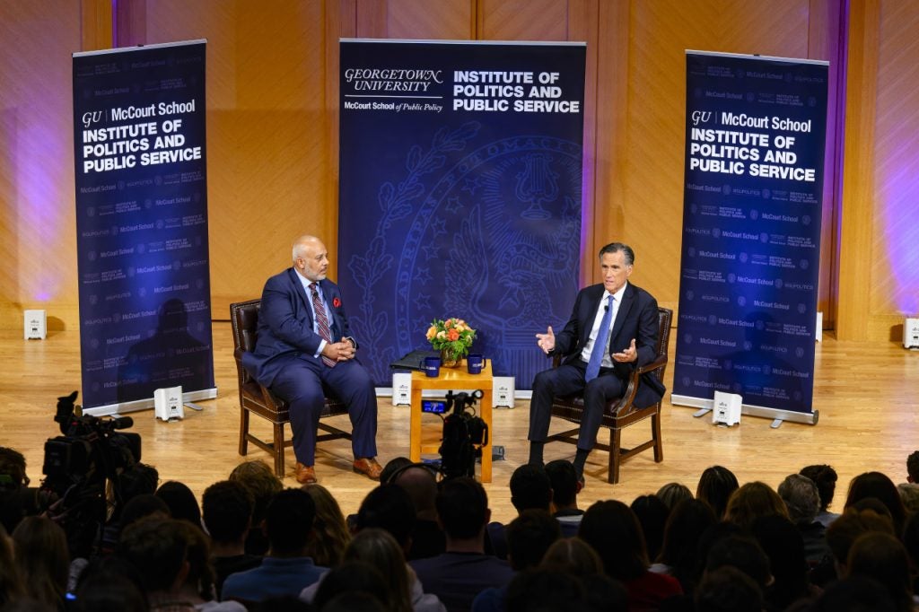 Mitt Romney and Mo Elleithee on stage