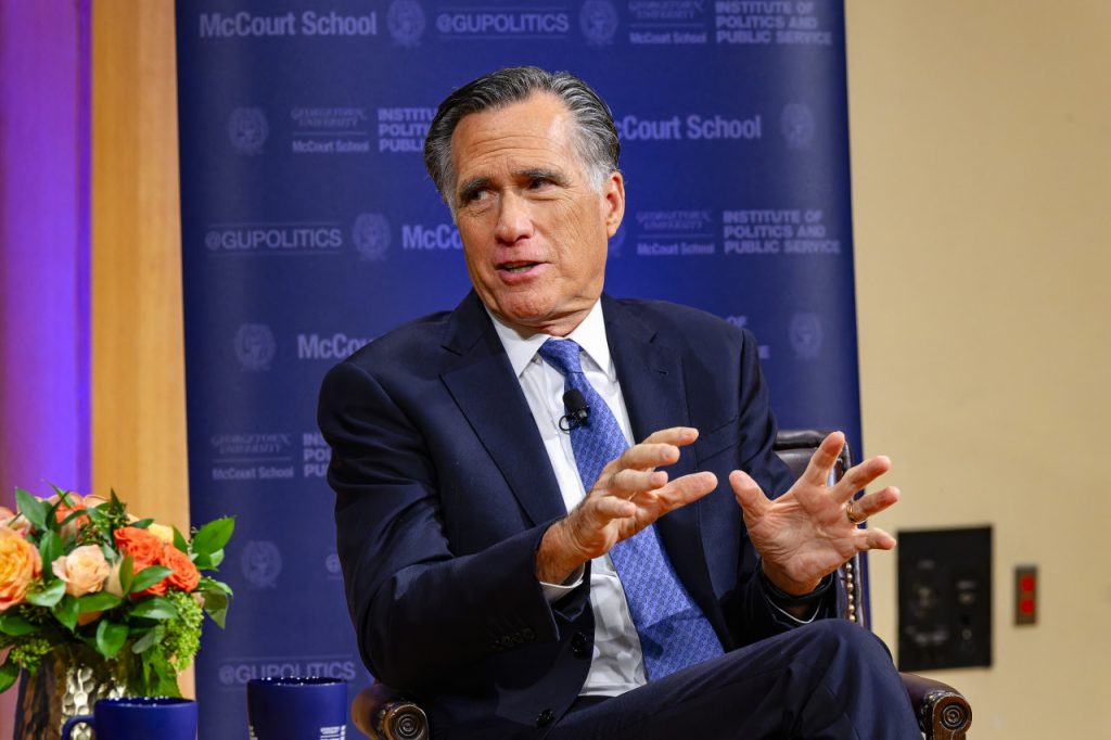 Mitt Romney speaking on stage