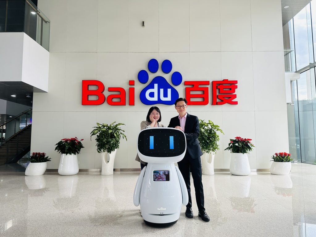 Charlie Wang stands at the entrance to Baidu, a tech and AI firm in Beijing.